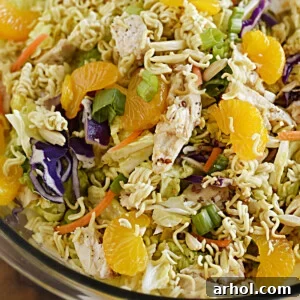 chinese ramen chicken salad with crunchy ramen noodles, napa cabbage and mandarin oranges in a serving bowl