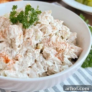 bowl of chicken salad with paprika and parsley.