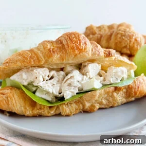 lemon chicken salad recipe in a croissant roll with lettuce