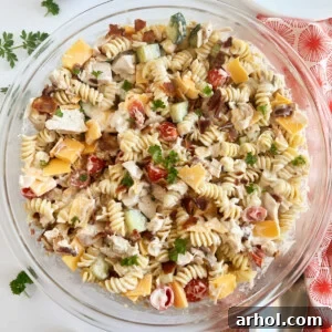 chicken bacon ranch pasta salad recipe in large glass bowl with parsley