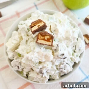Snickers apple salad with chopped snicker bars in a bowl