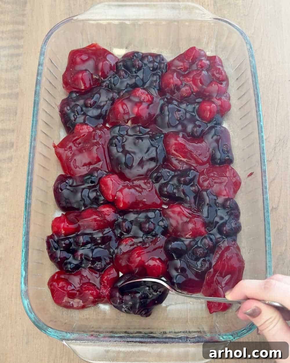 spooning pie filling into baking dish.