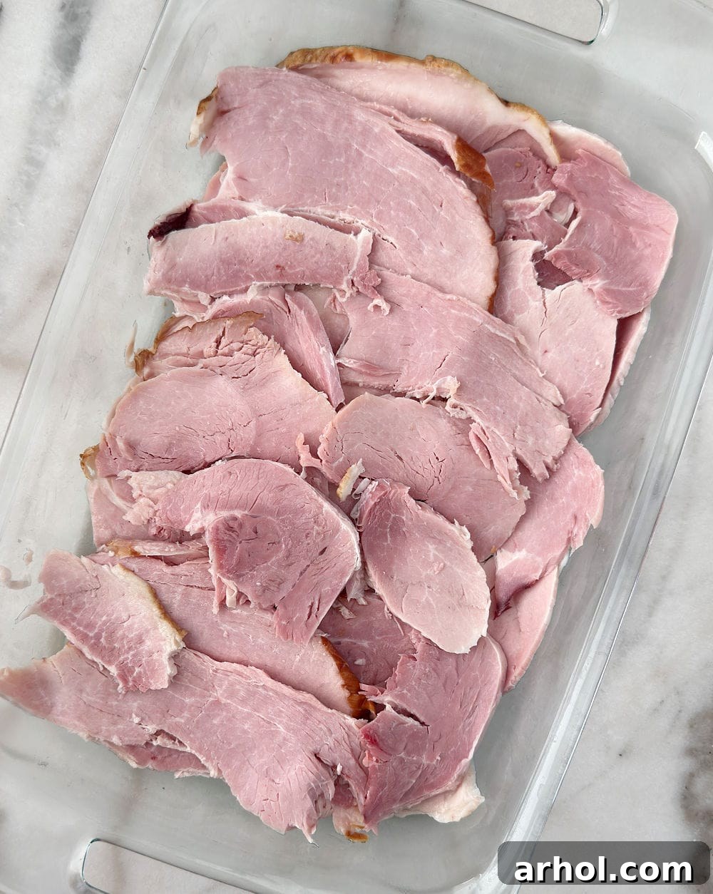 Perfect Oven-Baked Ham Slices: Easy, Juicy Recipe for Weeknight Dinners 5 slices of ham in casserole dish.