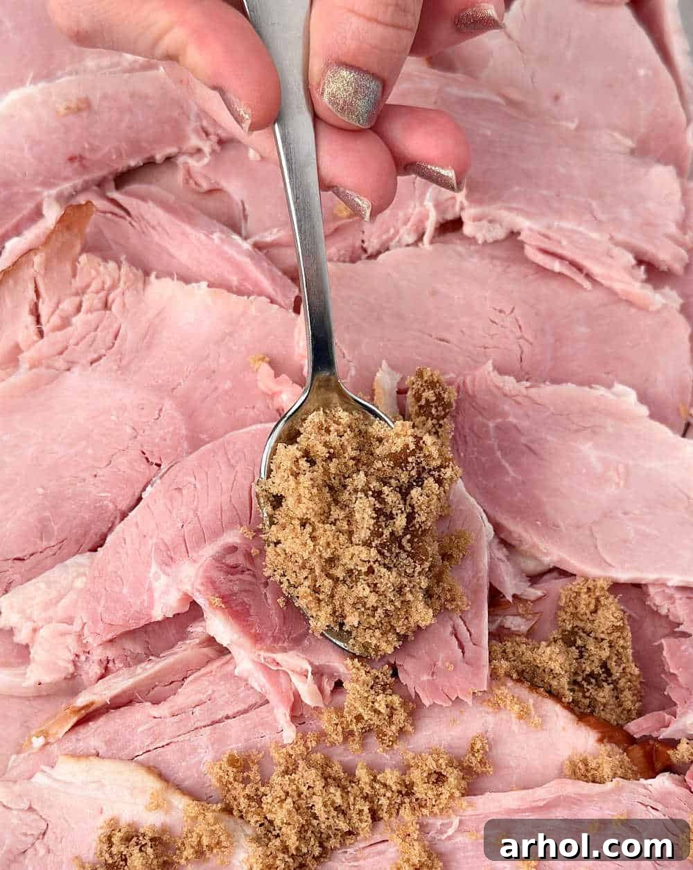 Perfect Oven-Baked Ham Slices: Easy, Juicy Recipe for Weeknight Dinners 6 spooning brown sugar honey mixture over ham.