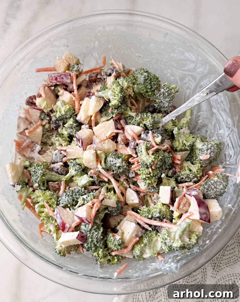 tossing salad with dressing.