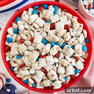 red white and blue puppy chow with patriotic m&m's and chex cereal in a red bowl.