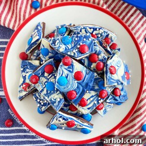 overhead pic of red white and blue bark with m and m candy on plate