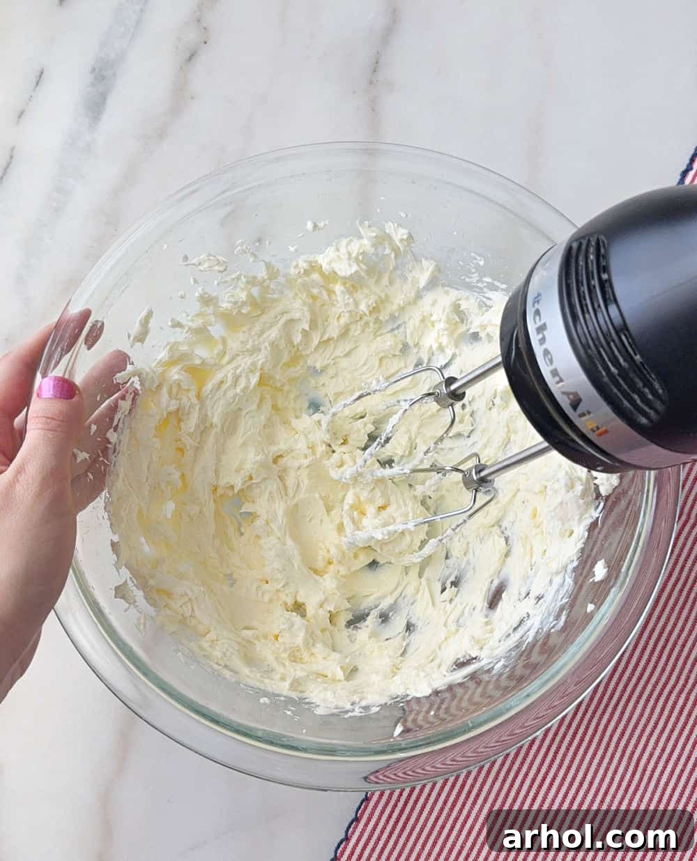 Patriotic Red, White & Blue Cheesecake Dip Recipe for Parties 5 mixing cream cheese with hand mixer in bowl.