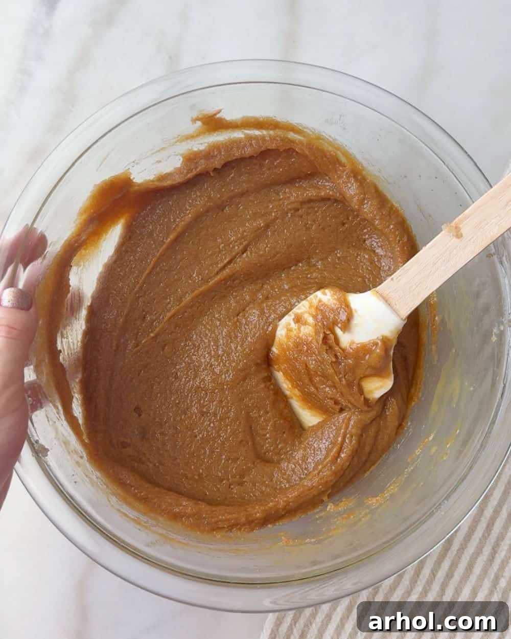 stirring wet ingredients in mixing bowl.
