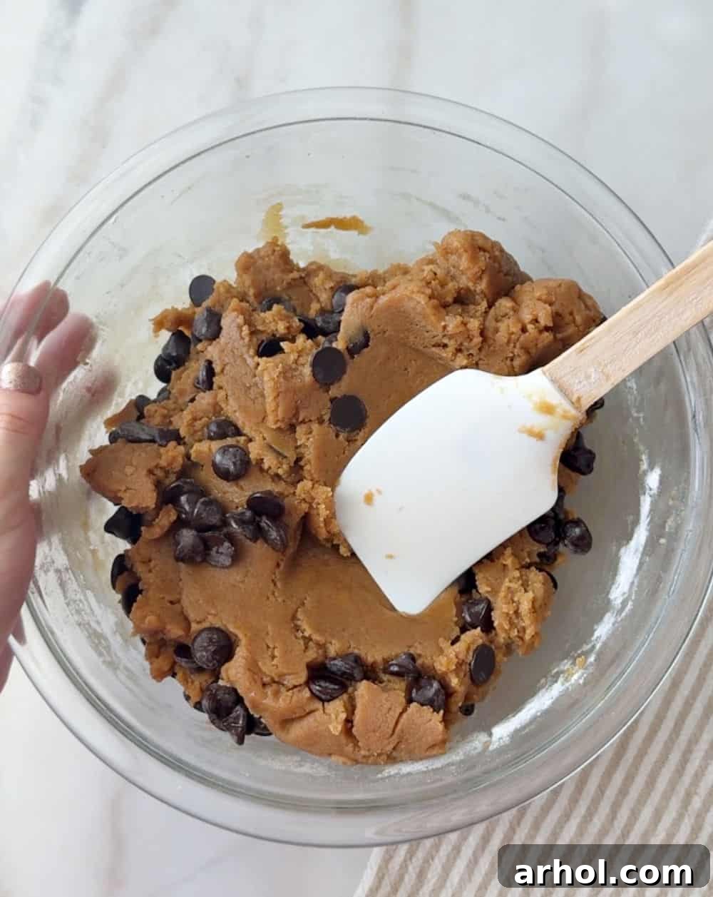 adding chocolate chips with spatula.