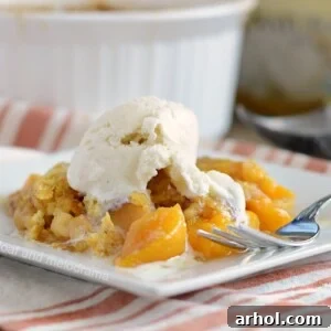 instant pot peach dump cake with vanilla ice cream on plate