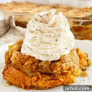 pumpkin dump cake with yellow cake mix topping and whipped cream on plate