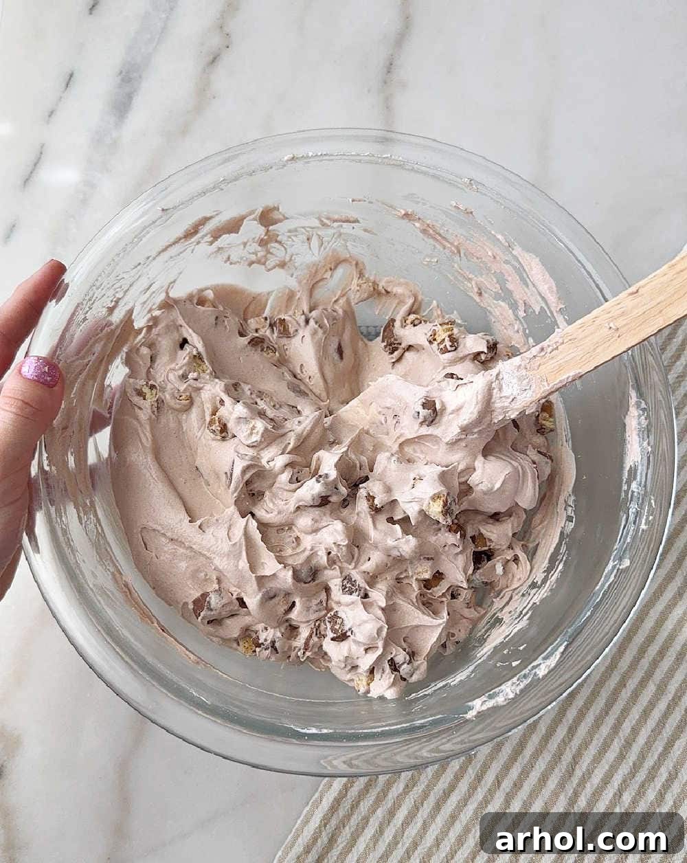 mixing in candy with spatula.