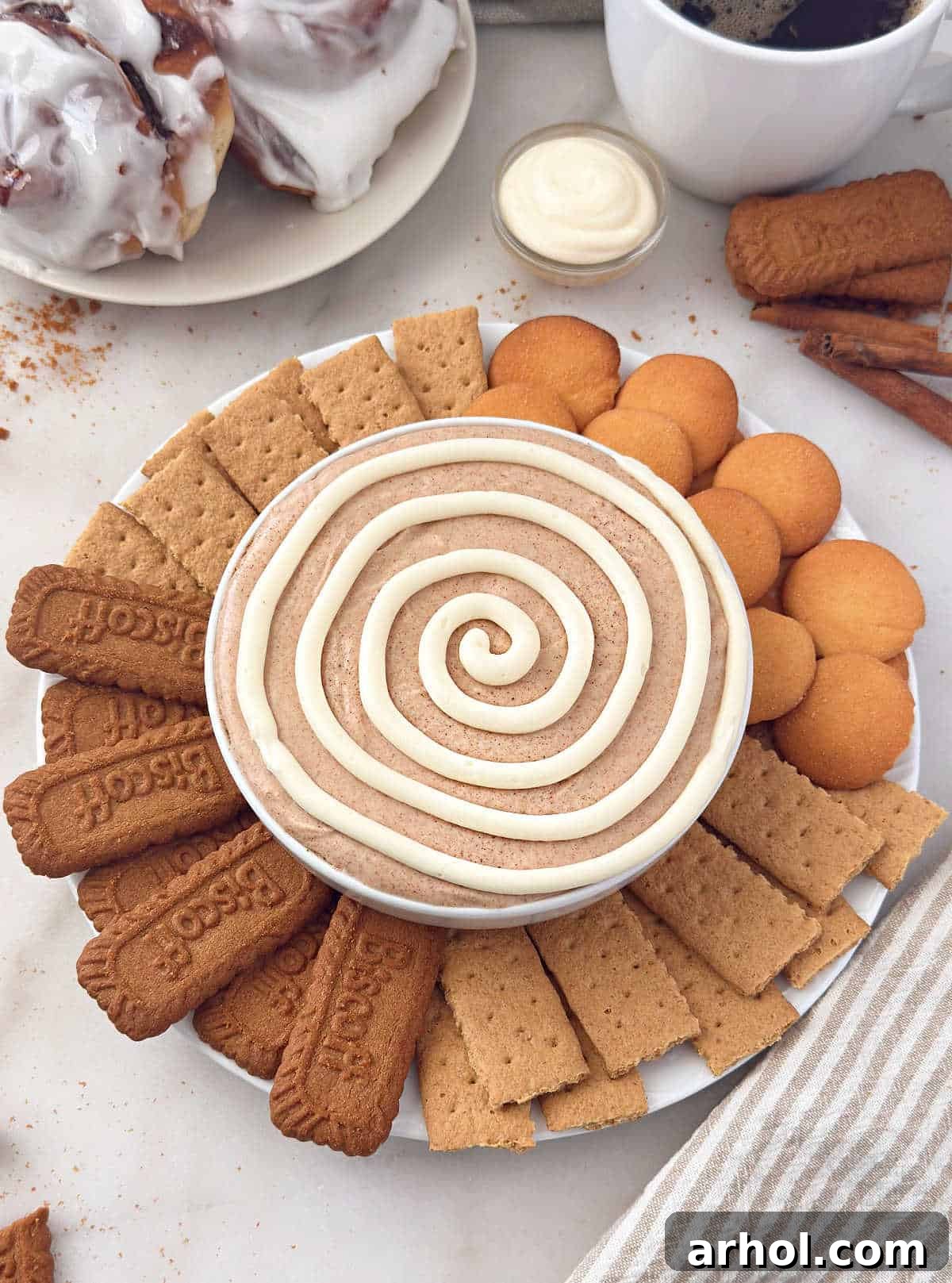 bowl of cinnamon roll dip with dippers.