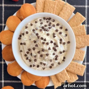 chocolate chip dip with mini chocolate chips in a bowl with graham crackers and cookies