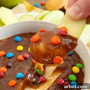 caramel apple dip on sliced apple with mini m and m's