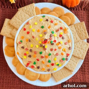 pumpkin pie dip with fall sprinkles and cookies in a white bowl