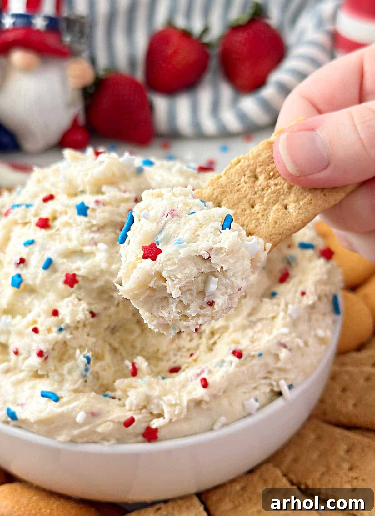 red, white and blue funfetti dip on graham cracker.