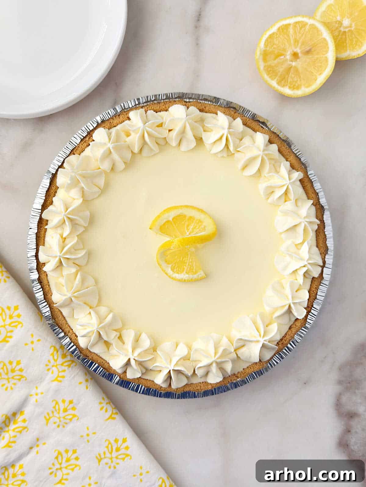 No-Bake Creamy Lemon Jello Pie 9 No-bake lemon jello pie garnished with lemon twist and whipped cream.