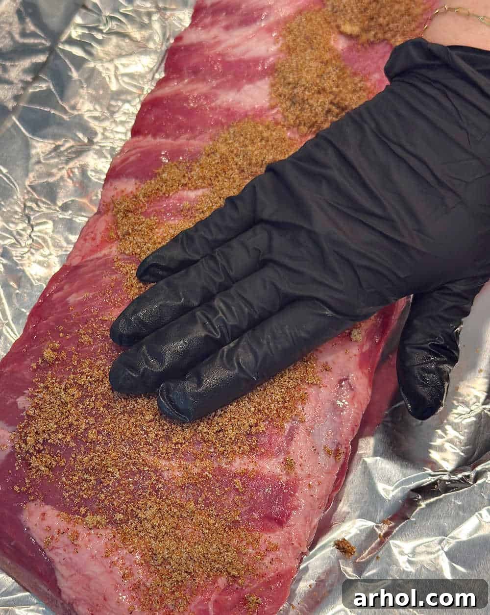 rubbing spice mixture over ribs.