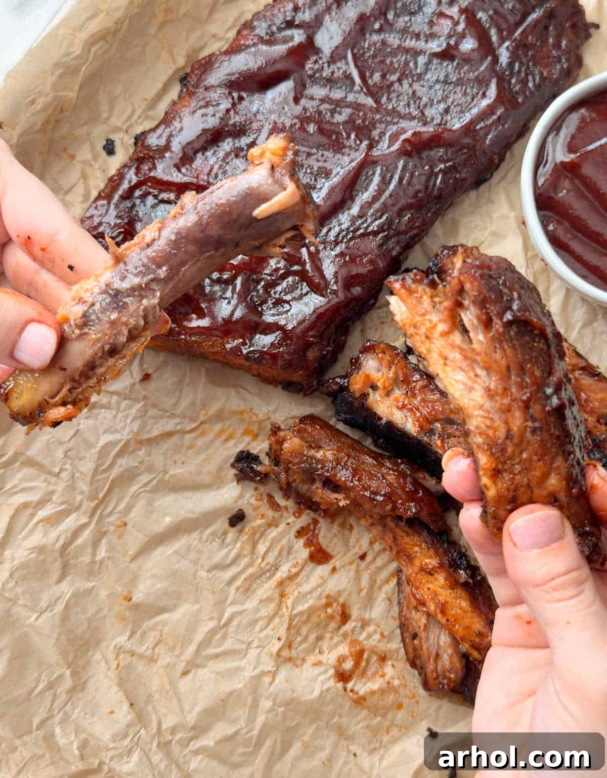 fall off the bone baked pork ribs in hand.