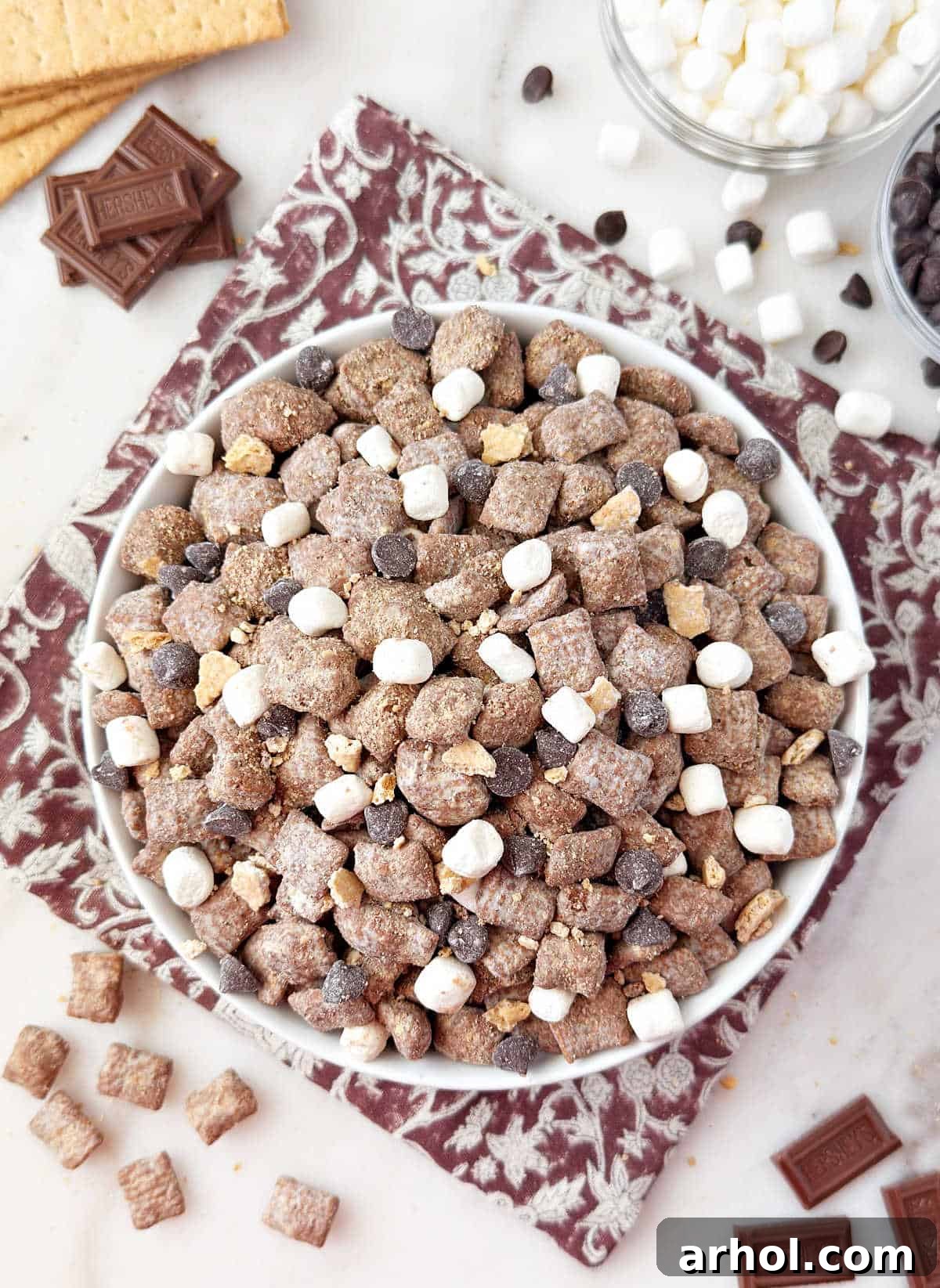 bowl of smores puppy chow with marshmallows and chocolate.