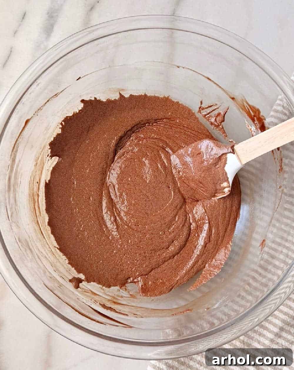 mixing chocolate mixture in glass bowl.