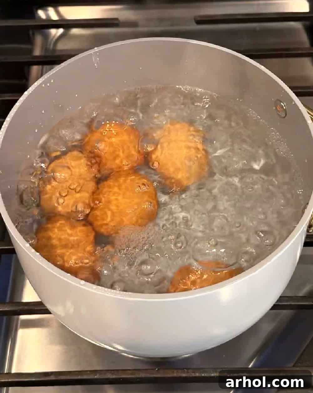 eggs boiling in pot of water.