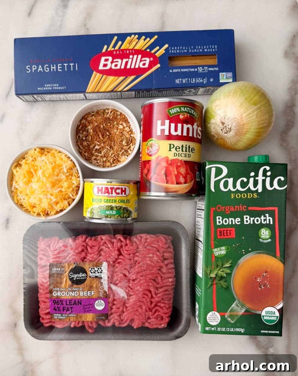 spaghetti noodles, ground beef, seasoning, cheese, chiles, tomatoes, onion, broth.
