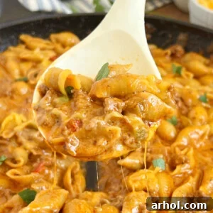 cheesy taco pasta on a serving spoon.