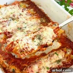 beef and cheese manicotti on a serving spoon.