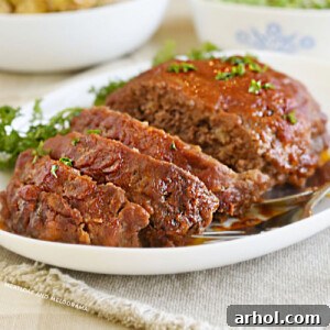 meatloaf with tomato sauce and brown sugar glaze on white platter