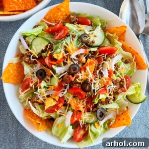 dorito taco salad with ground beef taco meat and catalina dressing and doritos on the table