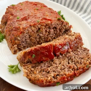 Quaker oats meatloaf with ketchup glaze sliced on a platter.