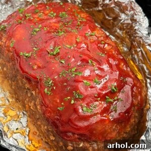 crockpot meatloaf topped with glaze and parsley.