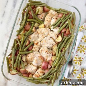 Italian chicken with potatoes and green beans in pan.