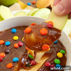 caramel apple dip on sliced apple with mini m and m's