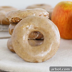 glazed apple spice cake donut with apples on the table