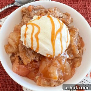 slow cooker apple cobbler with cake mix topping and vanilla ice cream