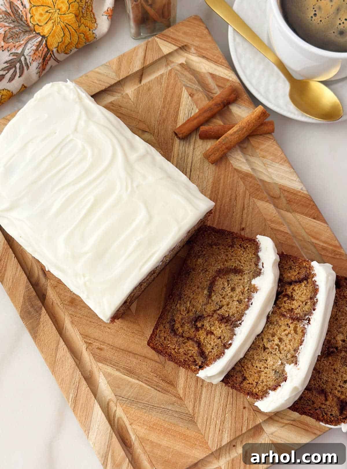 cinnamon roll banana bread sliced on cutting board.