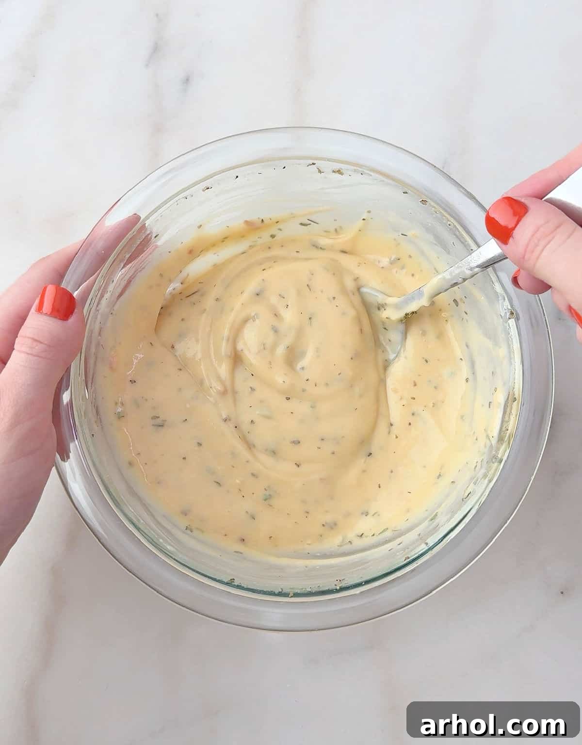 mixing sauce in bowl.