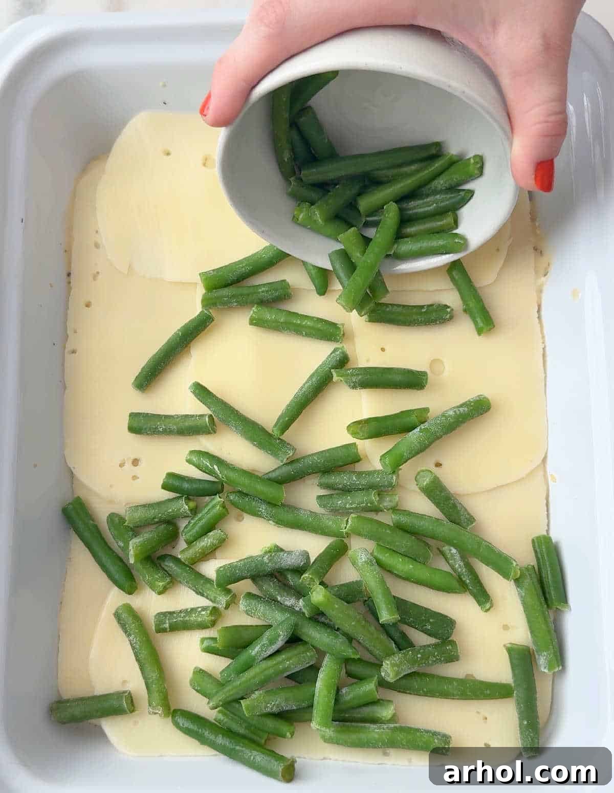 adding green beans over cheese layer.
