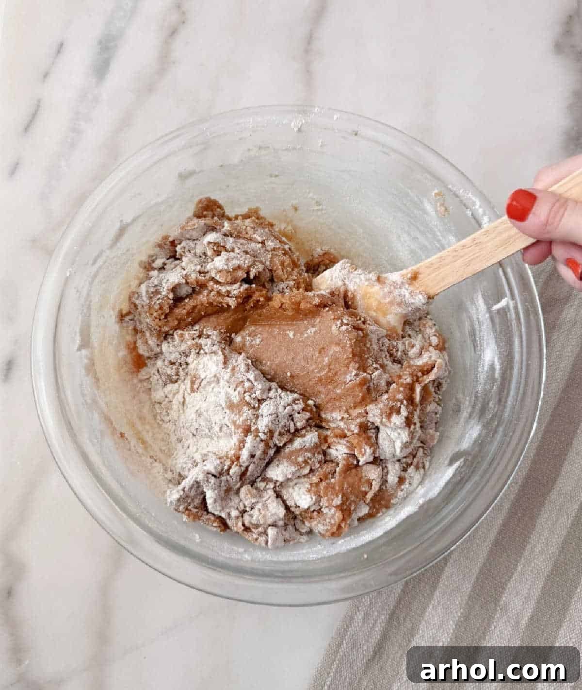 mixing wet with dry ingredients in bowl.