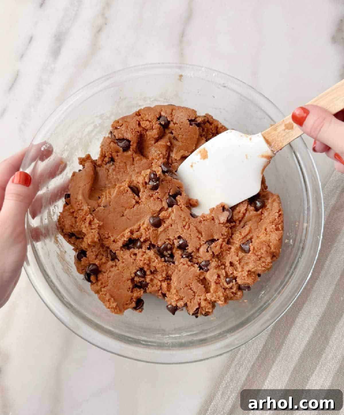 adding chocolate chips and cookies with spatula.