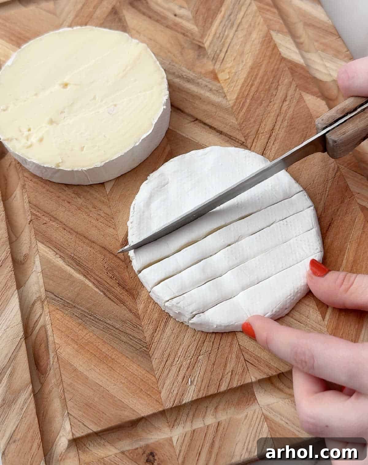 slicing brie into strips.
