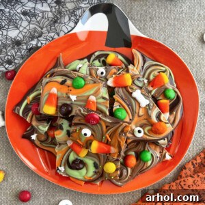 Halloween candy bark with candy corn on a jack o lantern plate.